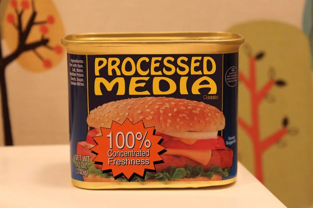 Processed Media logo — a satirical Spam-style can labeled 'Processed Media: 100% Concentrated Freshness'